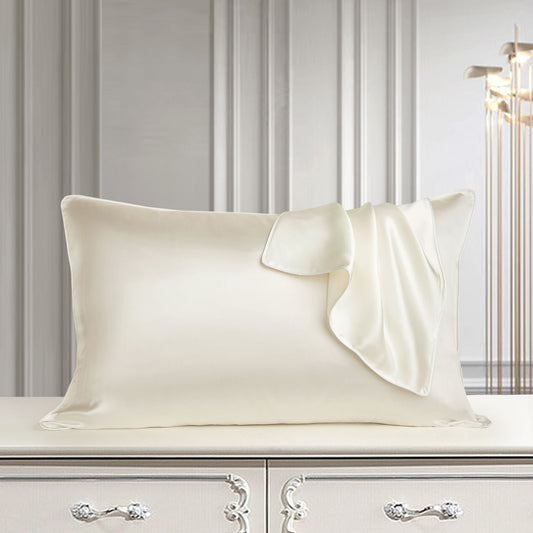 Nocturne Mulberry Silk Pillowcase in champagne on a bed